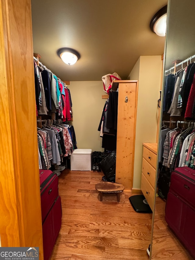 spacious closet featuring light hardwood / wood-style floors