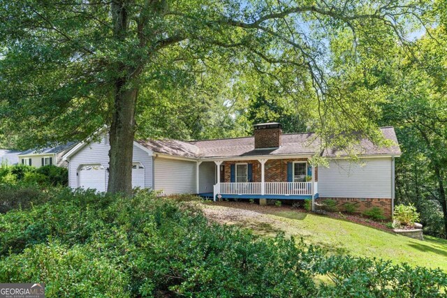 single story home featuring a garage and a front lawn