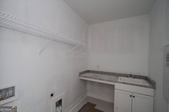 laundry area featuring sink, electric dryer hookup, hookup for a washing machine, and cabinets