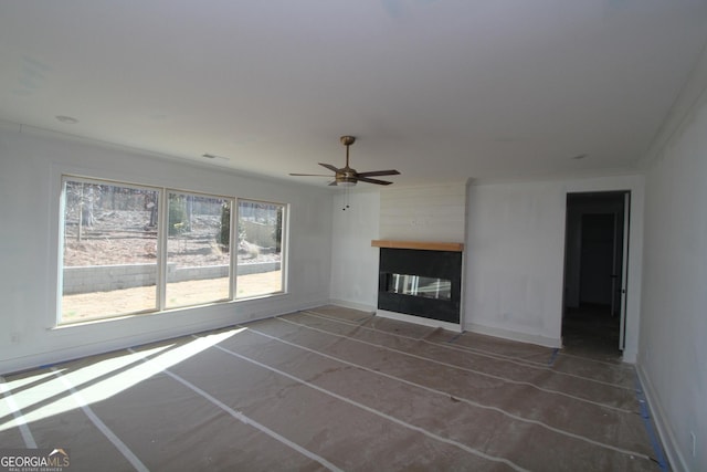 unfurnished living room with a fireplace, ceiling fan, and crown molding