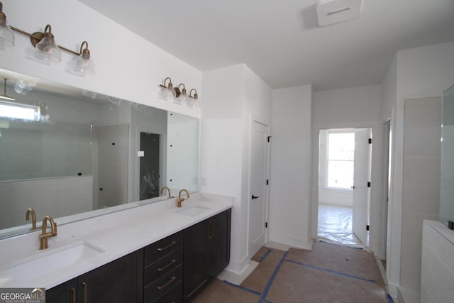 bathroom featuring a shower and vanity