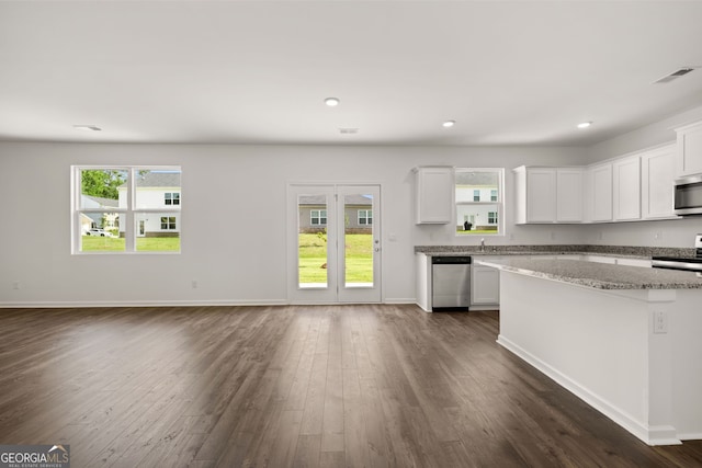 kitchen with white cabinets, stainless steel appliances, dark hardwood / wood-style floors, and a wealth of natural light