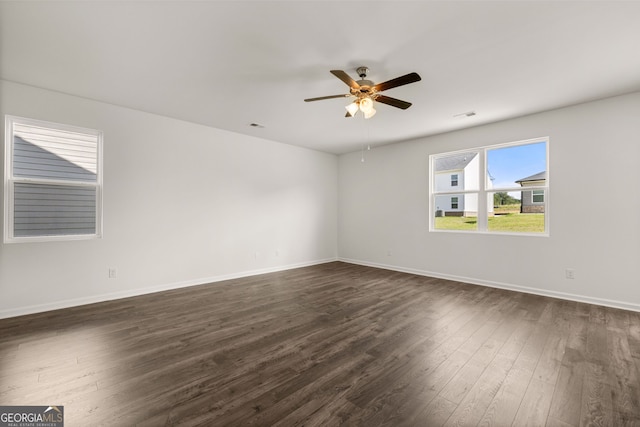 spare room featuring ceiling fan and dark wood-type flooring