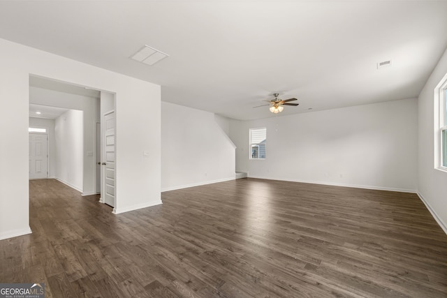 unfurnished living room featuring ceiling fan and dark wood-type flooring