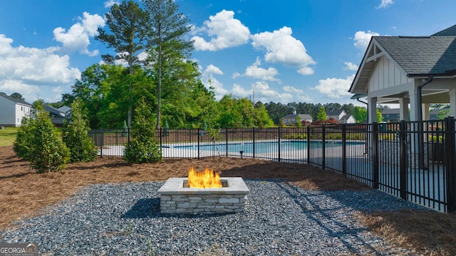 exterior space featuring a fenced in pool and an outdoor fire pit