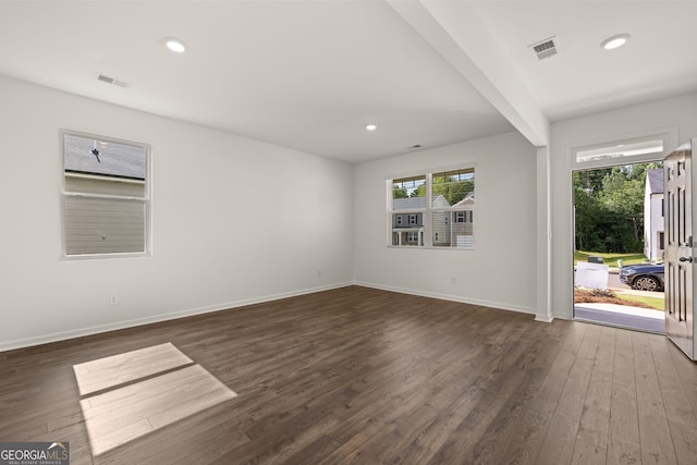 interior space featuring beam ceiling and dark hardwood / wood-style floors