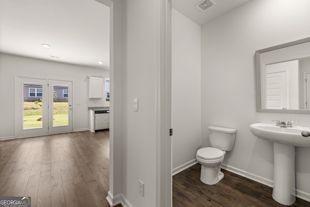 bathroom featuring sink, hardwood / wood-style floors, and toilet