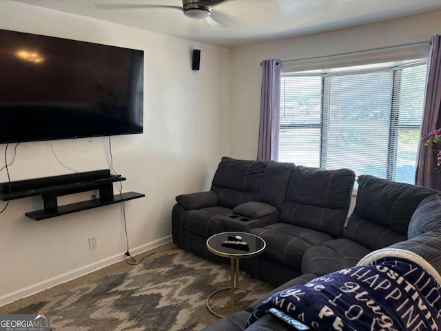 living room featuring a ceiling fan, carpet flooring, and baseboards