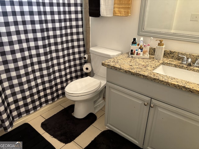 bathroom featuring vanity, toilet, tile patterned floors, and a shower with curtain