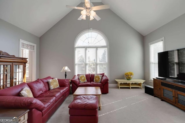 living room featuring light carpet, ceiling fan, and high vaulted ceiling