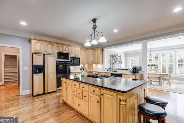 kitchen with pendant lighting, light wood-type flooring, black appliances, crown molding, and a chandelier