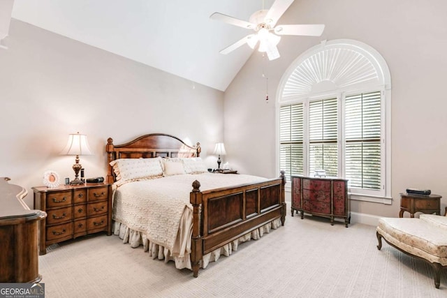 carpeted bedroom featuring high vaulted ceiling and ceiling fan