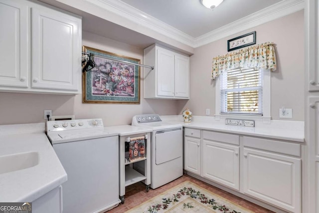 laundry area with light hardwood / wood-style flooring, ornamental molding, washer and dryer, and cabinets