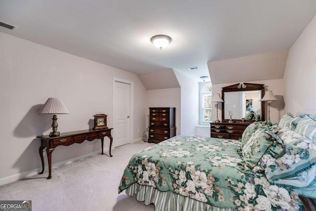 bedroom with lofted ceiling and light colored carpet