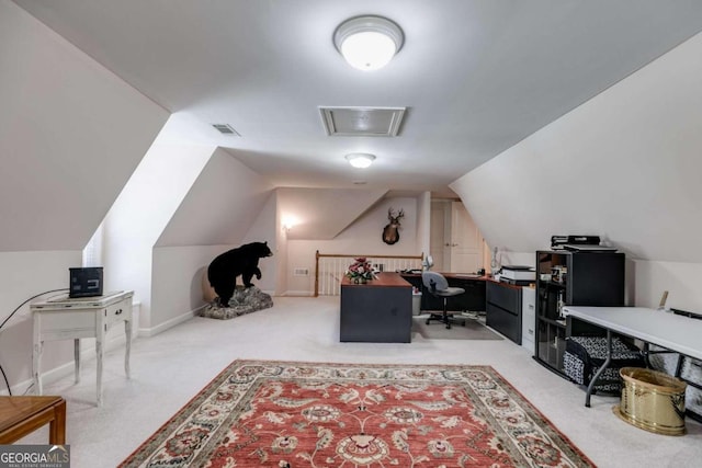 carpeted office with lofted ceiling