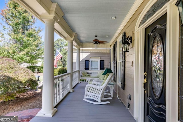 wooden deck featuring ceiling fan and a porch