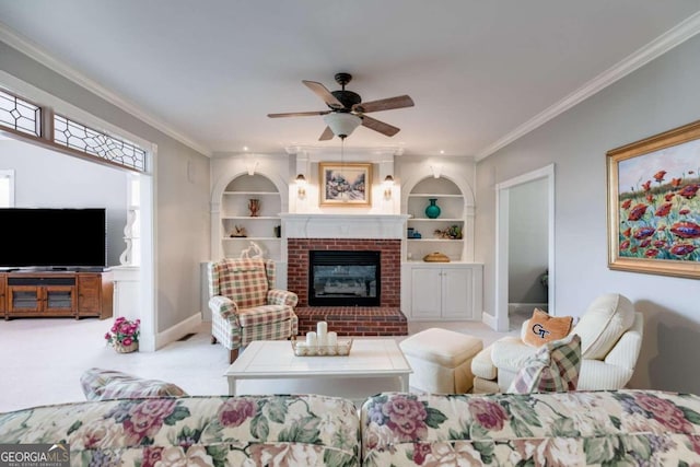 carpeted living room featuring crown molding, ceiling fan, built in features, and a brick fireplace