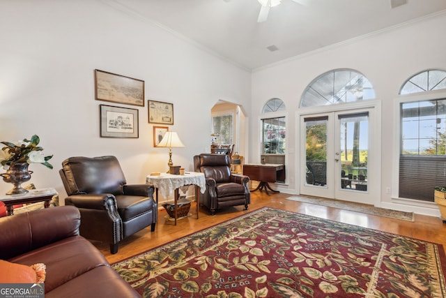 living area featuring ceiling fan, hardwood / wood-style flooring, french doors, and ornamental molding