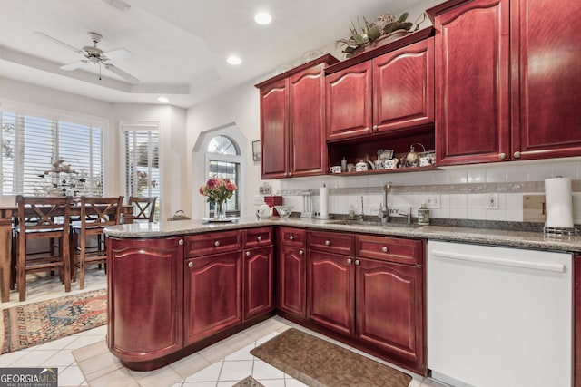 kitchen with light tile patterned flooring, sink, tasteful backsplash, ceiling fan, and stainless steel dishwasher