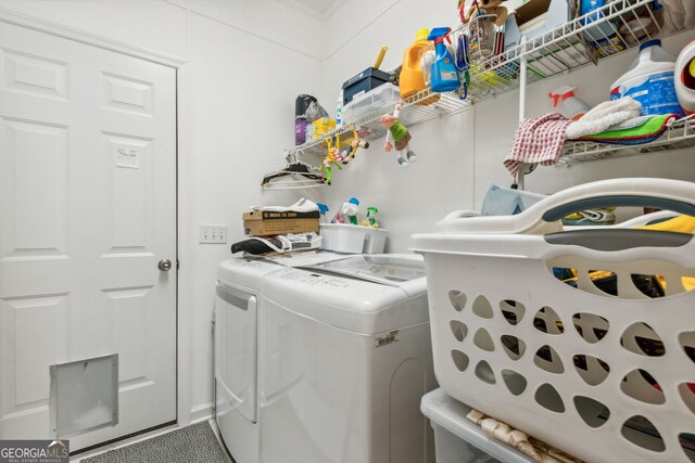 clothes washing area with washing machine and dryer