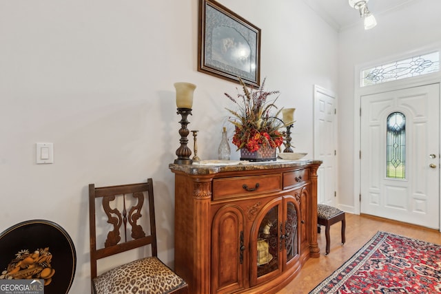 entrance foyer featuring crown molding