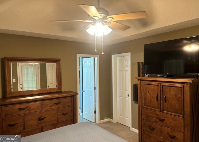 bedroom featuring light colored carpet and ceiling fan