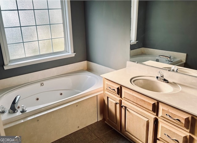 bathroom featuring tile patterned floors, a bath, and vanity