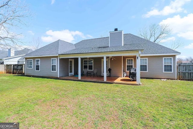 back of house featuring a patio, ceiling fan, and a lawn