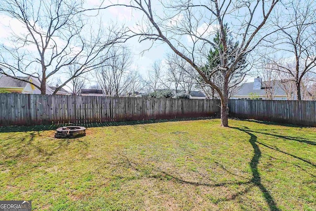 view of yard featuring an outdoor fire pit