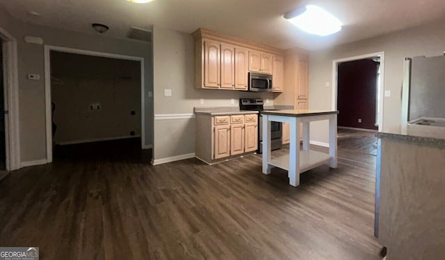 kitchen featuring dark hardwood / wood-style flooring and stainless steel appliances