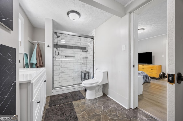 bathroom with hardwood / wood-style flooring, vanity, walk in shower, toilet, and a textured ceiling