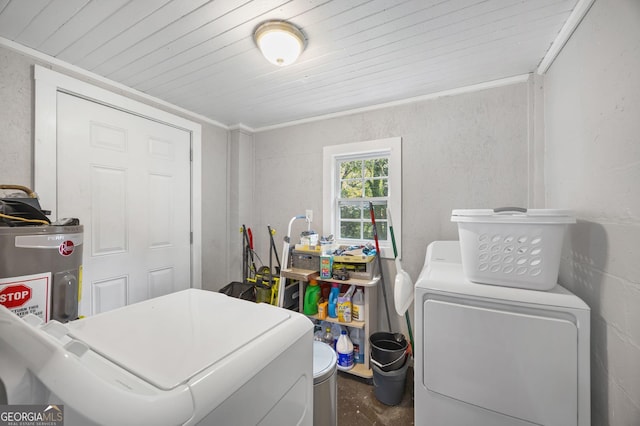 laundry room with washing machine and clothes dryer, ornamental molding, and water heater