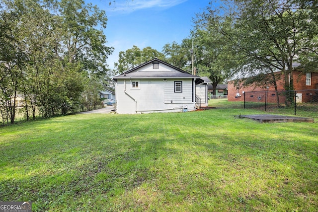 rear view of house featuring a lawn