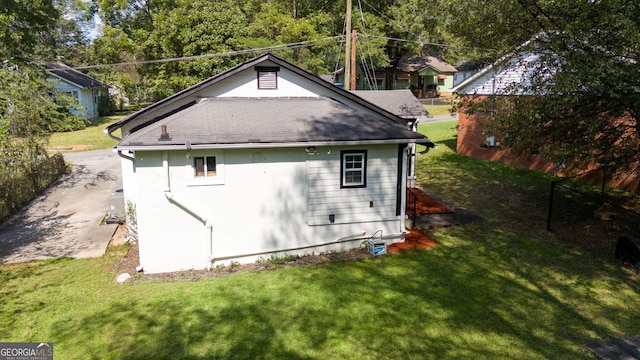 view of side of home featuring a yard