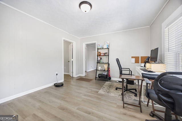 office area with crown molding, light hardwood / wood-style flooring, and a textured ceiling