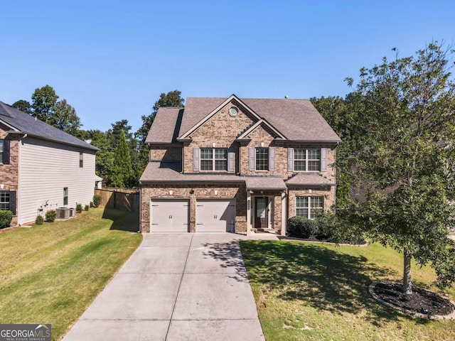 view of front of property with central AC, a front yard, and a garage