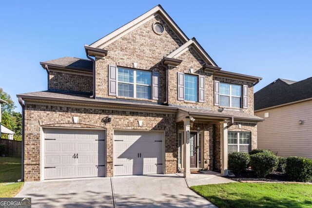 view of front facade with a front yard and a garage