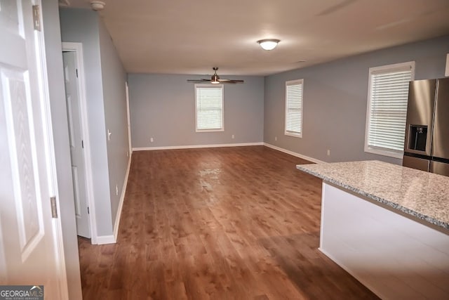 interior space with ceiling fan and dark hardwood / wood-style floors