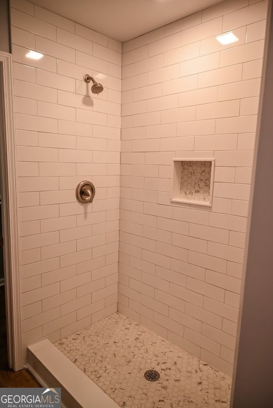 bathroom with a tile shower