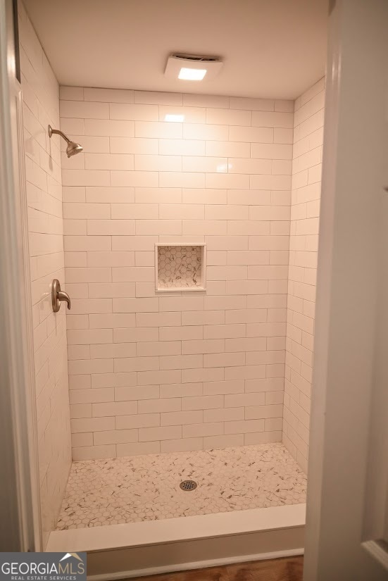 bathroom with tiled shower