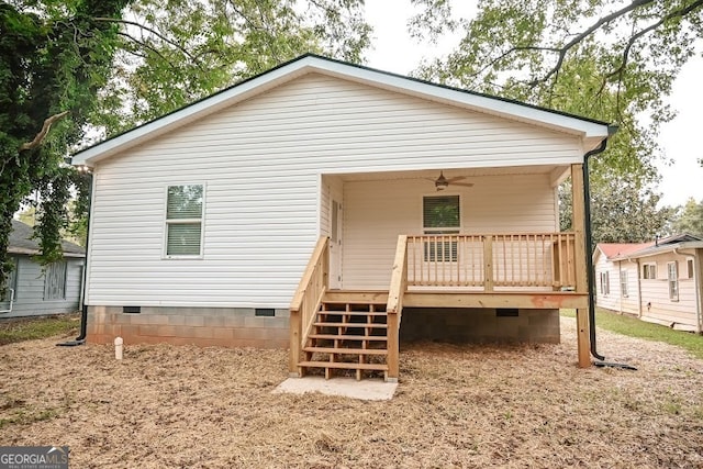 rear view of property with ceiling fan and a deck