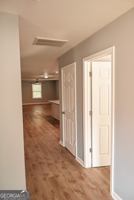 corridor featuring light hardwood / wood-style floors