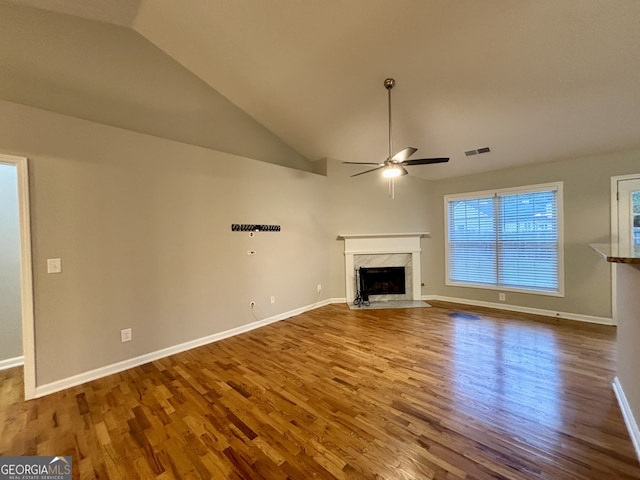 unfurnished living room with wood-type flooring, a fireplace, and vaulted ceiling