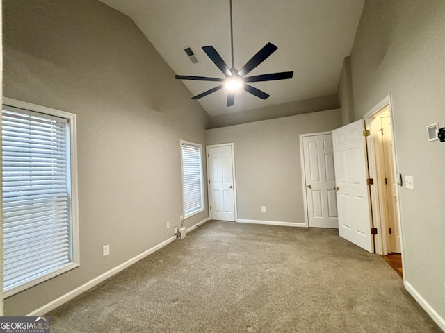 unfurnished bedroom featuring high vaulted ceiling, carpet, and ceiling fan