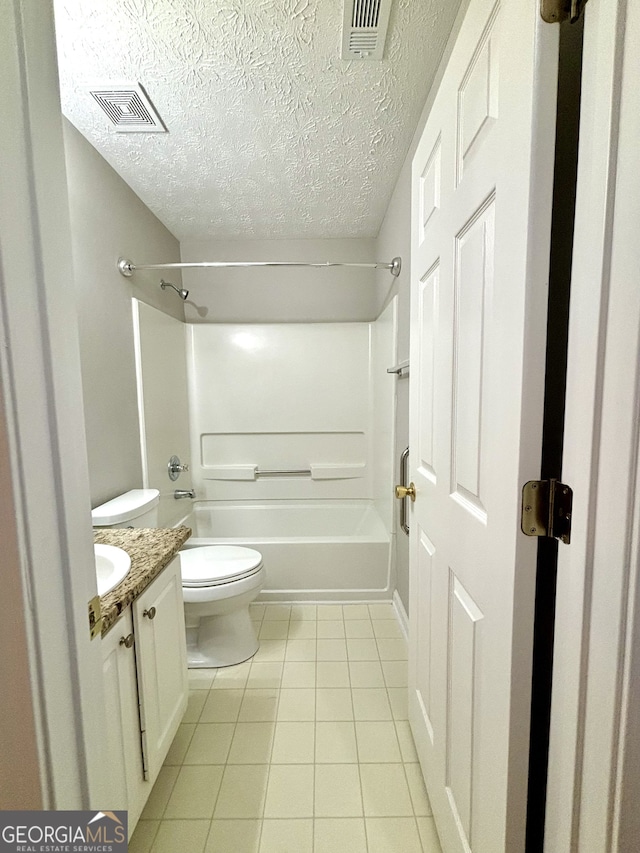 full bathroom with vanity, a textured ceiling, shower / bathing tub combination, toilet, and tile patterned floors