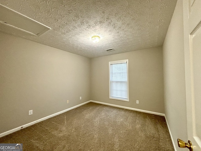 carpeted spare room featuring a textured ceiling