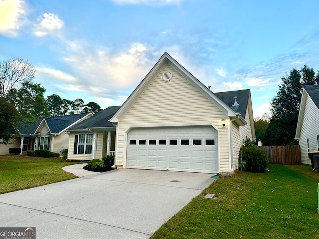 view of front of property with a front yard and a garage