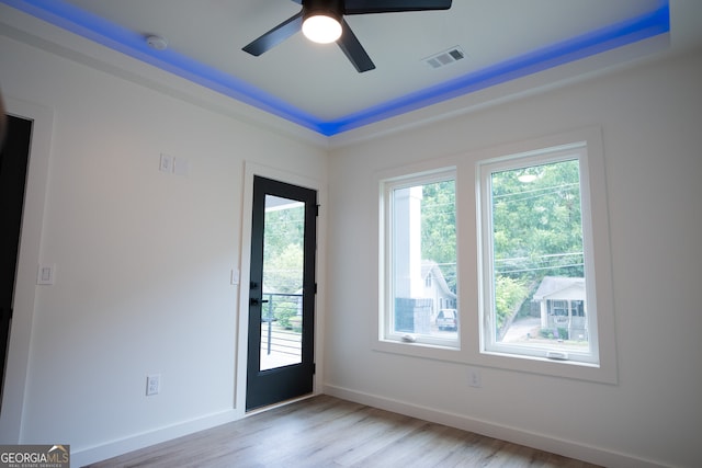 spare room with ceiling fan and light wood-type flooring