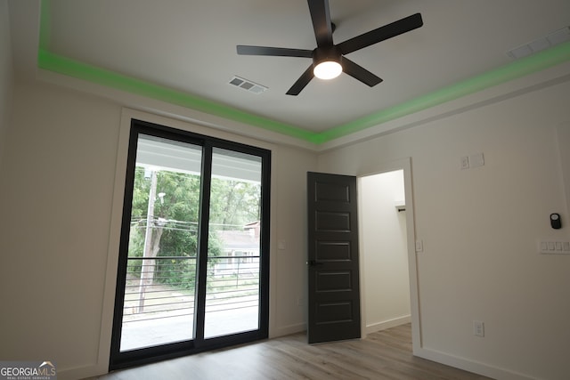 interior space with light wood-type flooring, access to outside, and ceiling fan