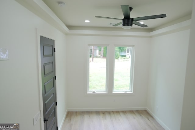 empty room with ceiling fan and light wood-type flooring